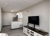 Thumbnail 22 of 22 - a living room with a tv and a kitchen
