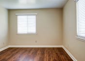 Thumbnail 8 of 25 - A room with a window and wooden floors.