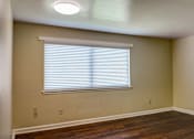 Thumbnail 3 of 25 - A room with a window covered by white blinds.