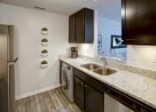 Thumbnail 29 of 46 - Kitchen with a sink and a washing machine at Gramercy on Garfield, 45202