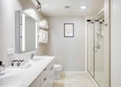 Thumbnail 23 of 49 - A white bathroom with a sink, mirror, toilet and shower.at Sky Central, Cincinnati, 45202