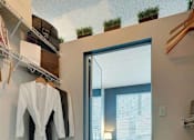 Thumbnail 21 of 49 - A bedroom with a bed, a window, and a closet with clothes hanging.at Sky Central, Ohio