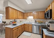 Thumbnail 14 of 54 - a large kitchen with wooden cabinets and stainless steel appliances at Indian Creek Apartments, Ohio, 45236