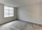 Thumbnail 36 of 46 - Empty room with a window and concrete floor at Gramercy on Garfield, 45202