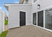 Thumbnail 22 of 40 - A house with a black door and a white fence.