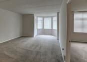 Thumbnail 38 of 46 - Empty living room with a large window and carpet at Gramercy on Garfield, Cincinnati, Ohio