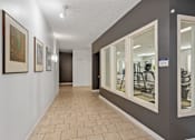 Thumbnail 16 of 42 - a resident fitness center with mirrors on the wall and a tiled floor at DeSales Flats Apartments*, Ohio, 45206