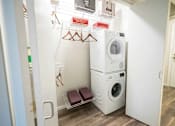 Thumbnail 25 of 49 - A small laundry room with a washer and dryer stacked on top of each other.at Sky Central, Cincinnati, 45202