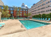 Thumbnail 46 of 46 - Pool with green chairs around it in front of a building at Gramercy on Garfield, Cincinnati, 45202