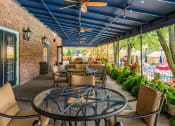 Thumbnail 42 of 54 - Patio with tables and chairs and a blue ceiling at Indian Creek Apartments, Cincinnati, OH, 45236