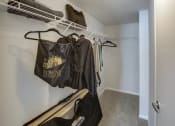 Thumbnail 39 of 46 - Walk in closet with clothes hanging on a rack in a home at Gramercy on Garfield, Cincinnati, Ohio