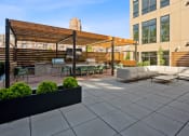 Thumbnail 67 of 81 - a patio with couches and tables and a bar and a building at Four23/Hoge, Cincinnati, OH, 45226