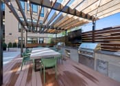Thumbnail 69 of 81 - a large outdoor kitchen with a dining table and a television at Four23/Hoge, Cincinnati, OH, 45226