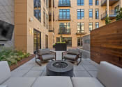 Thumbnail 72 of 81 - a patio with a couch and chairs and a fire pit at Four23/Hoge, Cincinnati, OH, 45226