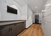 Thumbnail 56 of 81 - a long hallway with white walls and wooden floors and a white refrigerator and a door at Four23/Hoge, Ohio, 45226