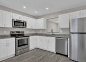 Thumbnail 5 of 40 - modern kitchen with white cabinets and stainless steel appliances