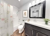 Thumbnail 5 of 35 - a bathroom with a toilet sink and shower and a mirror at Lawrence Landing, Indianapolis