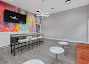 Thumbnail 57 of 57 - a living room with a bar with stools and a television at Indian Lookout Apartments, West Carrollton, 45449