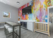 Thumbnail 50 of 57 - a break room with a table and chairs and a television at Indian Lookout Apartments, West Carrollton, 45449