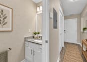 Thumbnail 7 of 40 - A bathroom with a white door and a brown rug.