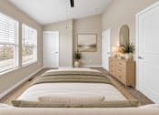 Thumbnail 19 of 40 - A bedroom with a long bed and a ceiling fan.