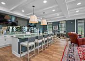Thumbnail 20 of 64 - A kitchen with a long table and chairs.
