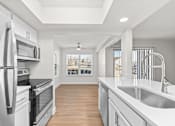 Thumbnail 22 of 51 - A modern kitchen with stainless steel appliances and wooden flooring.at Crooked Creek, Indianapolis, 46268
