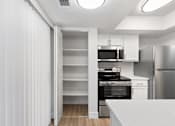 Thumbnail 34 of 51 - A modern kitchen with a refrigerator, oven, and microwave.at Crooked Creek, Indiana
