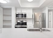 Thumbnail 26 of 51 - A modern kitchen with stainless steel appliances and white cabinetry.at Crooked Creek, Indianapolis, 46268