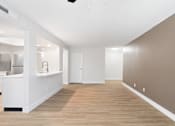 Thumbnail 33 of 51 - A room with a white kitchen area and a wooden floor.at Crooked Creek, Indianapolis