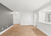 Thumbnail 21 of 51 - A long, empty room with wooden floors and white walls.at Crooked Creek, Indianapolis, IN