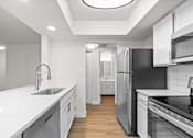 Thumbnail 18 of 51 - A modern kitchen with white cabinets and stainless steel appliances.at Crooked Creek, Indiana