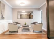 Thumbnail 31 of 54 - a living room with chairs and a coffee table and a mirror at Indian Creek Apartments*, Cincinnati, OH