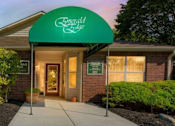 Thumbnail 26 of 27 - The front of a building with a green awning that says "Riverdale".