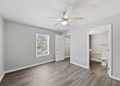 Thumbnail 17 of 27 - A room with a ceiling fan and a framed picture on the wall.