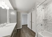 Thumbnail 20 of 27 - A bathroom with marble walls and a white sink.