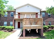 Thumbnail 23 of 27 - A red and white house with a wooden deck.