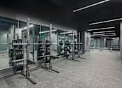 Thumbnail 46 of 49 - A gym with a variety of weightlifting equipment at Sky Central Apartments, Ohio