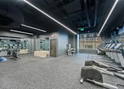 Thumbnail 45 of 49 - A gym with treadmills, weights, and exercise equipment at Sky Central Apartments, Cincinnati, OH