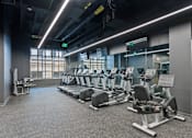 Thumbnail 47 of 49 - A gym with treadmills and elliptical machines at Sky Central Apartments, Cincinnati, OH, 45202