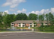 Thumbnail 18 of 21 - A parking lot in front of a building with a fountain in the middle.