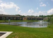 Thumbnail 16 of 21 - A pond in front of apartment buildings.