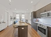 Thumbnail 14 of 81 - Kitchen with a large center island with a sink and a stove top oven at Four23/Hoge, Cincinnati, OH