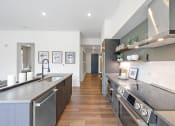 Thumbnail 23 of 81 - Kitchen with stainless steel appliances and a wooden floor at Four23/Hoge, Cincinnati, OH, 45226