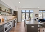 Thumbnail 25 of 81 - Kitchen with a large island and a view of the living room at Four23/Hoge, Cincinnati, OH, 45226
