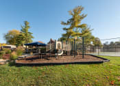 Thumbnail 52 of 54 - Playground with a slide and a swing set in a park at Indian Creek Apartments, Cincinnati, OH