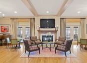 Thumbnail 39 of 54 - a living room with a fireplace and a table and chairs at Indian Creek Apartments*, Cincinnati, OH