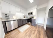 Thumbnail 1 of 35 - an empty kitchen with stainless steel appliances and white cabinets at Lawrence Landing, Indiana, 46226