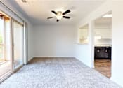 Thumbnail 14 of 35 - a living room with a ceiling fan and a glass door to a kitchen at Lawrence Landing, Indiana, 46226