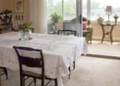 Thumbnail 6 of 25 - A dining room with a table set for a meal.